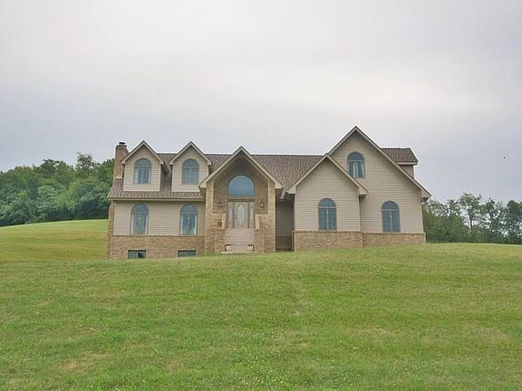 From the front, this property creates a stately and impressive picture with the beautiful stone work, roof lines, and plentiful 