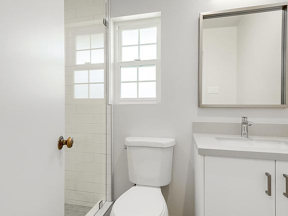 Completely remodeled bathrooms with quartz counter top, new cabinets and spacious tiled shower
