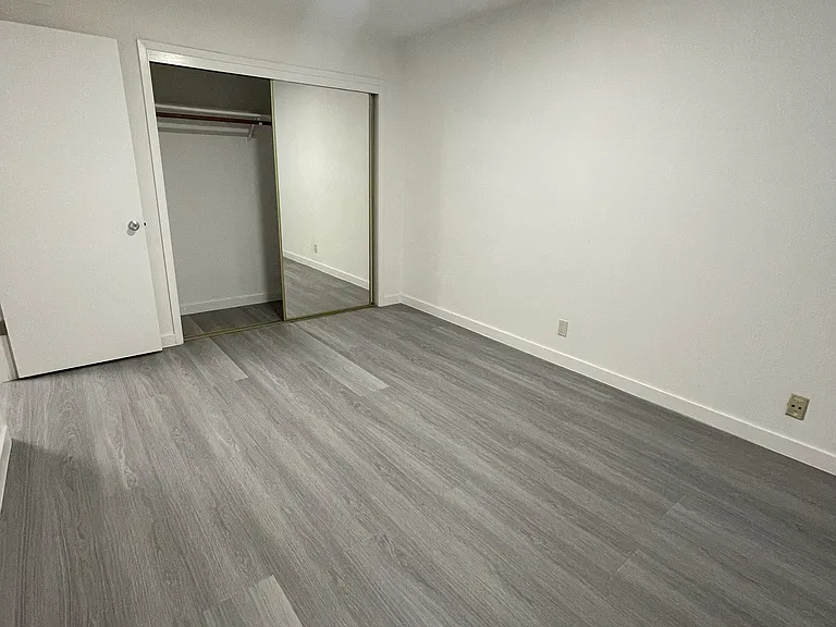 Bedroom with new flooring and window, spacious closet