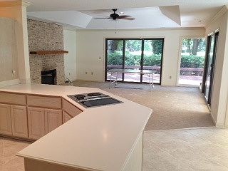Kitchen looking into Living room with other side of two way