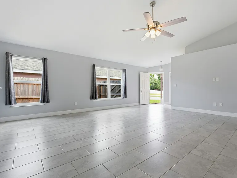 Living Room with vaulted ceilings and smart thermostat controller