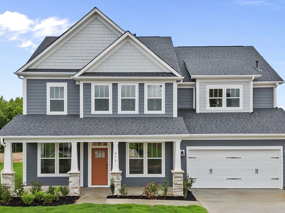 Craftsman exterior at Kayfield at Midway by DRB Homes with dark james hardie colorplus siding in And