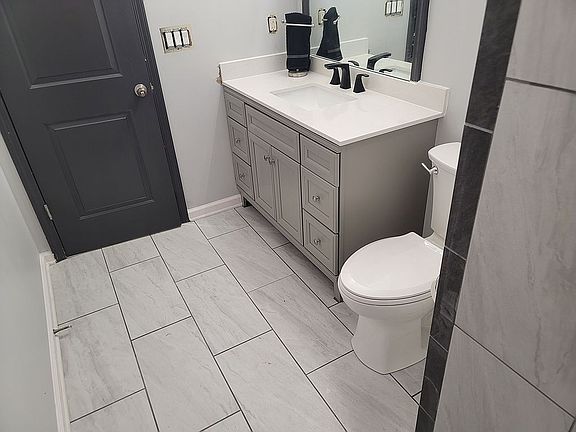 New tile, vanity, toilet & light