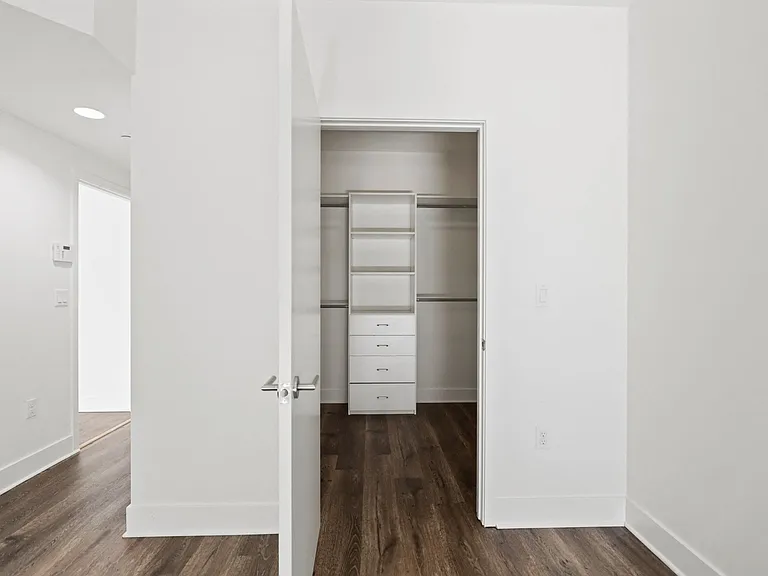 Bedroom with Closet with Built-In Shelving