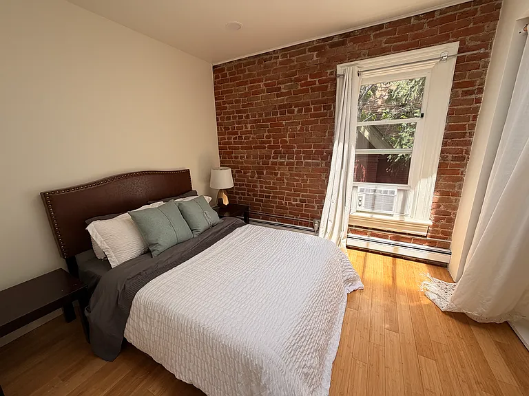 Third bedroom with gorgeous exposed brick and plenty of sun.