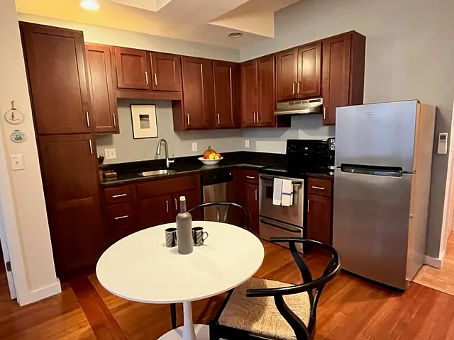 Dining and corner kitchen outfitted with dark granite counter tops, full oven/electric stove top, dishwasher, plenty of cabinet space.