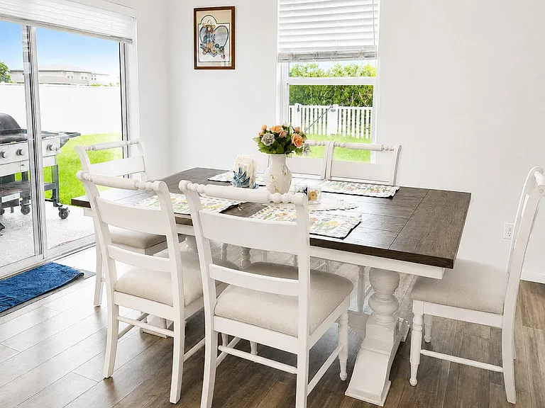 Dining area with a full-size table, seating for six, and easy access to the patio through sliding glass doors.