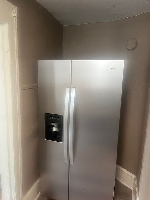 New side-by-side refrigerator with water/ice dispenser.