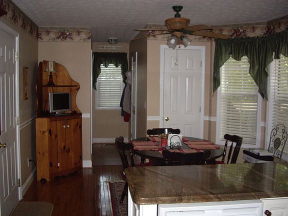 Kitchen with granite countertops, hardwood floors, and custom tile backsplash