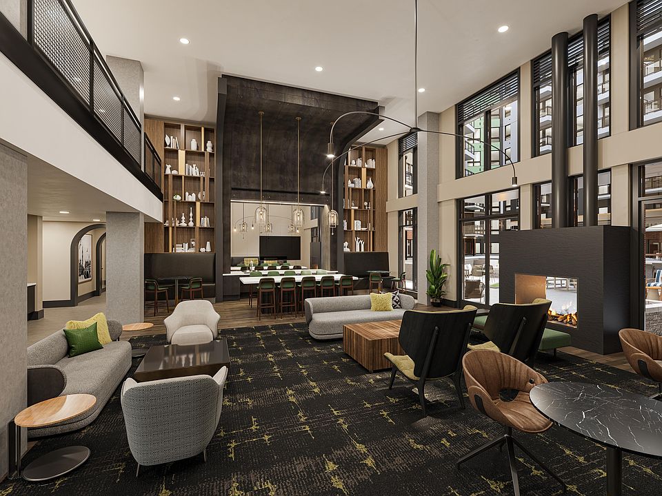 Expansive clubroom with gathering space, bar area, fireplace, and lounge seating at Modera H Street in Washington, D.C.