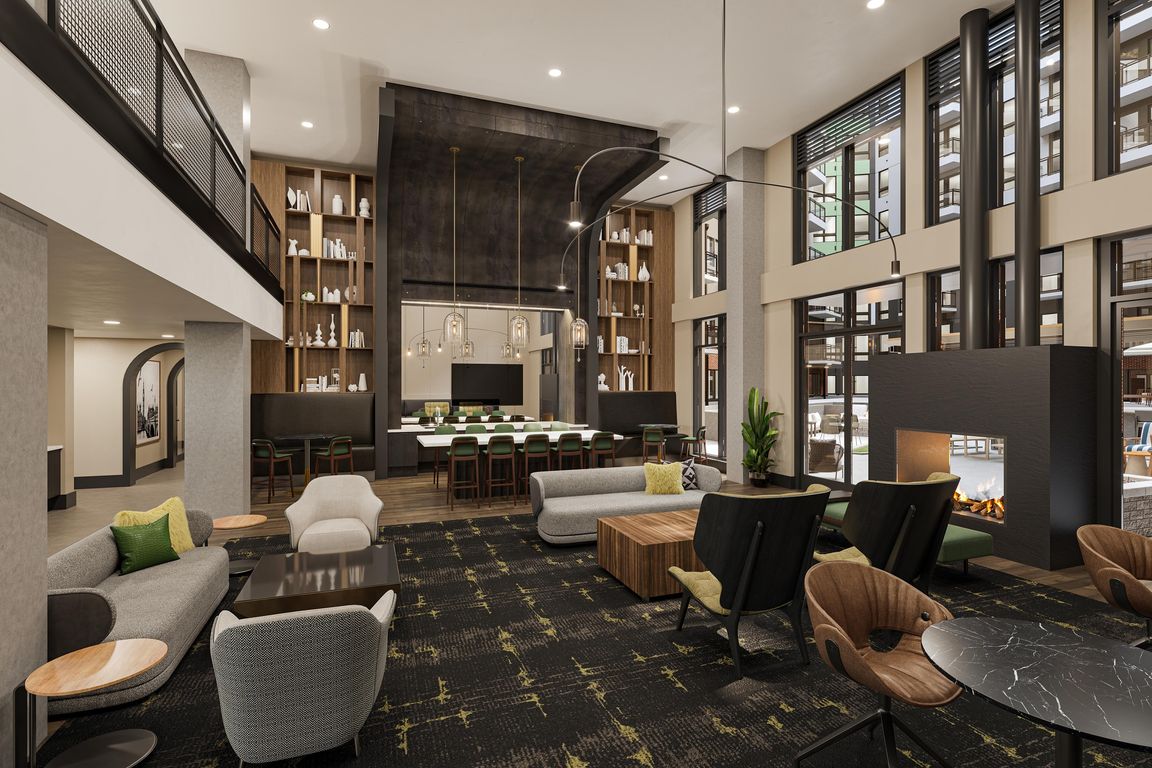 Expansive clubroom with gathering space, bar area, fireplace, and lounge seating at Modera H Street in Washington, D.C.