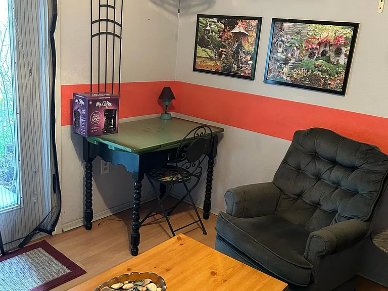 Farm table in the corder of the sitting room. Entrance (exit) is next to out, leading out to the back deck.