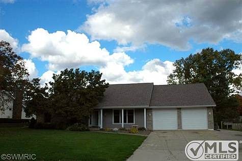 Don't be fooled by this modest front view, this home is full of amenities on Lloyds Bayou Channel!