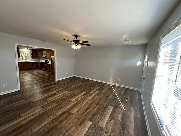 Side view of the living room. The front door is to the right of the photo. 
New Blinds as well.