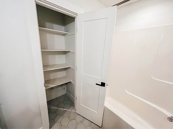 Convenient and spacious linen closet.