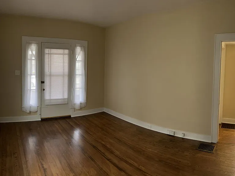 Living room, view 1 - Beautiful hard wood floors. On right is hallway leading to first floor bathroom and bedroom.