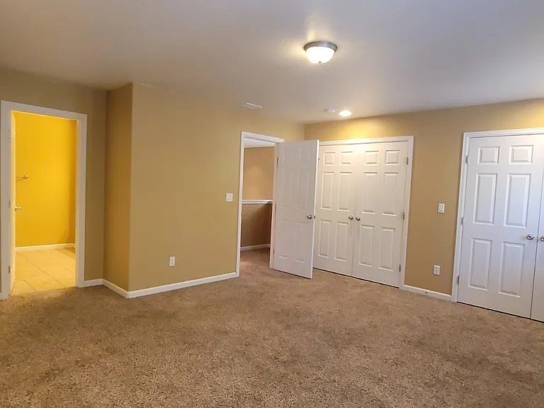 Looking out of the master bedroom to the hall and to the master bathroom on the left.