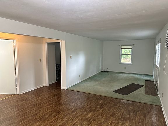 Dining room leads into the carpeted living room.