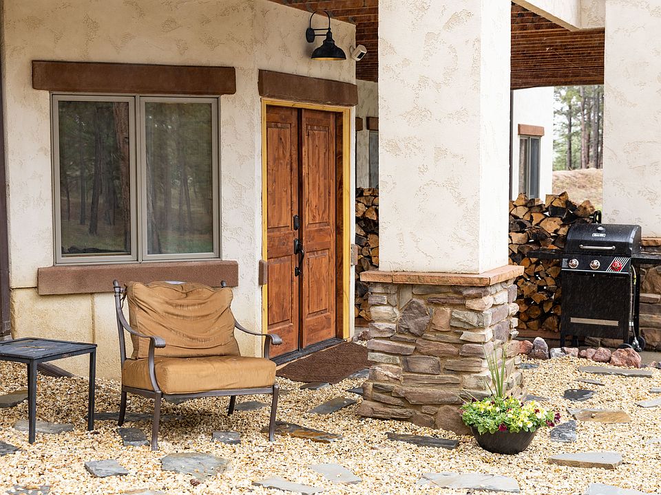 Outdoor patio area with furniture and grill