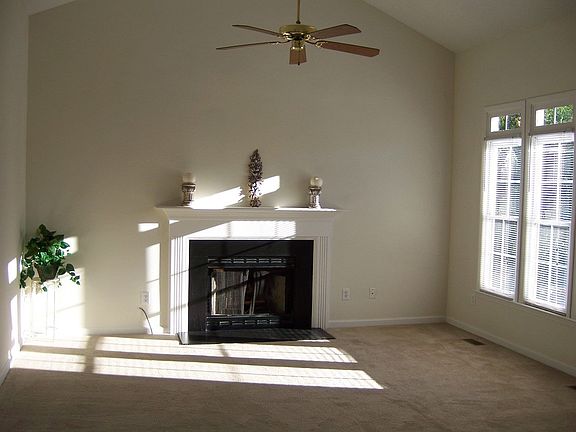 Large, open living room with cathedral ceilings and a masonry fireplace!
