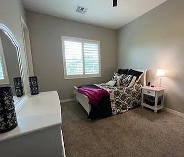 Bedroom 3 with Full size bed, nightstand and dresser with mirror. Also ceiling fan and walk in closet.