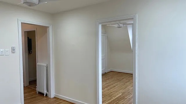 View from living/dining room area into the entrance hallway and bedroom