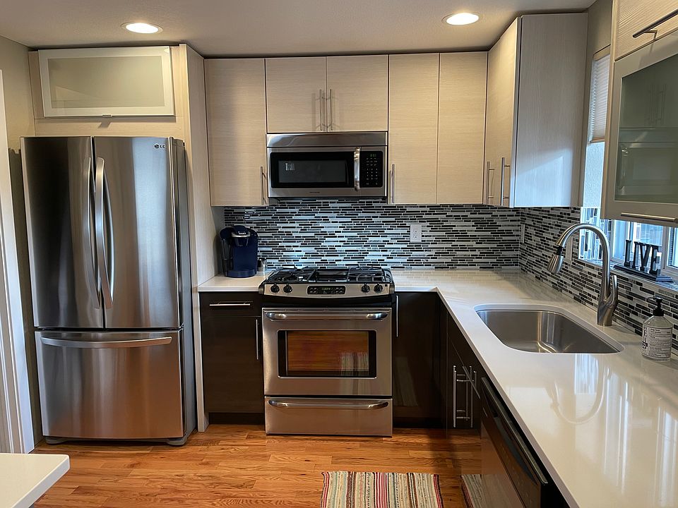 Euro-modern kitchen with stainless steel appliances and quartz countertops