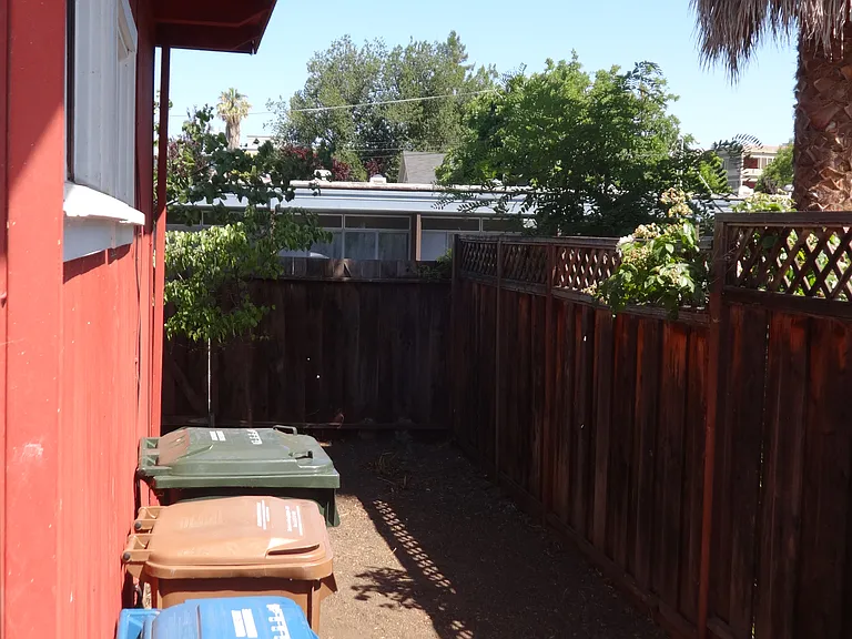 The side of the property with access between the front and backyards.
