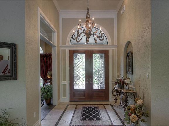 Front entry features high ceilings, custom molding, double leaded glass doors 