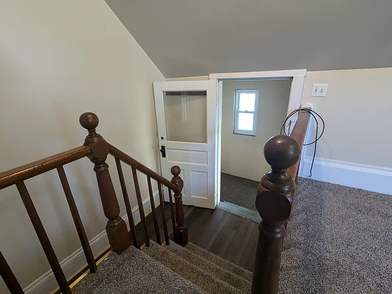 Inside small staircase going from entry to apartment living room