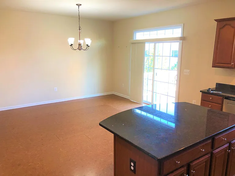 Kitchen opens to spacious dining area, which leads out to deck.