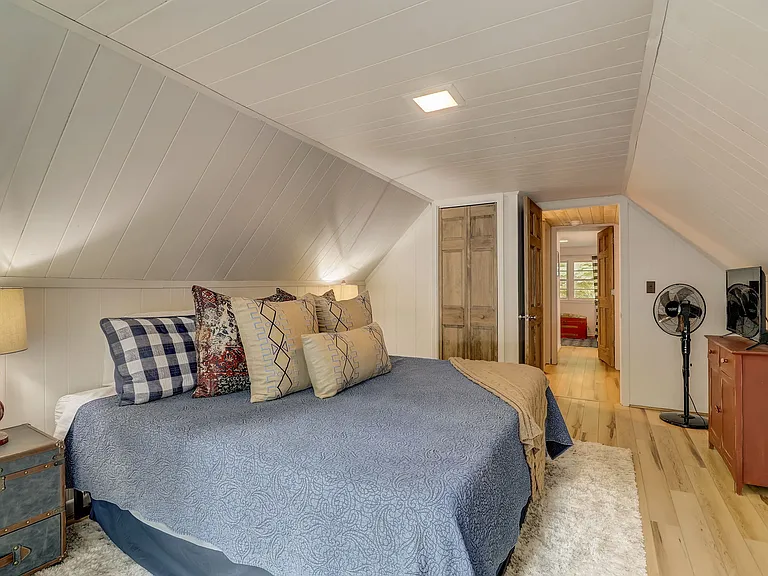 Upstairs primary bedroom with balcony and king size bed