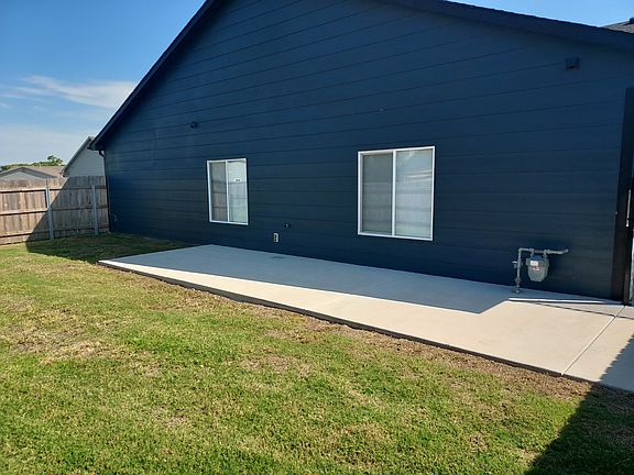 Side yard with patio view of 2332 E. Cheyenne Ct., Kechi, Kansas.