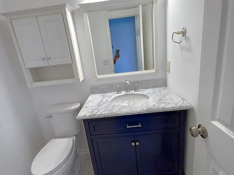 This property has undergone 100% renovation. Special order Carrara marble top cobalt blue vanity , new mirror new toilet new Carrara marble floors.