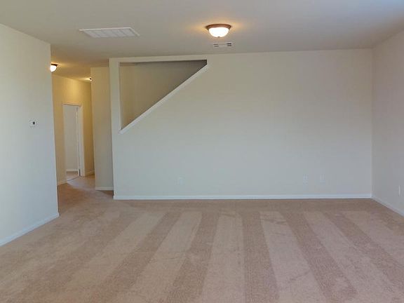 SPACIOUS FAMILY ROOM OVERLOOKING THE DINING AREA AND KITCHEN