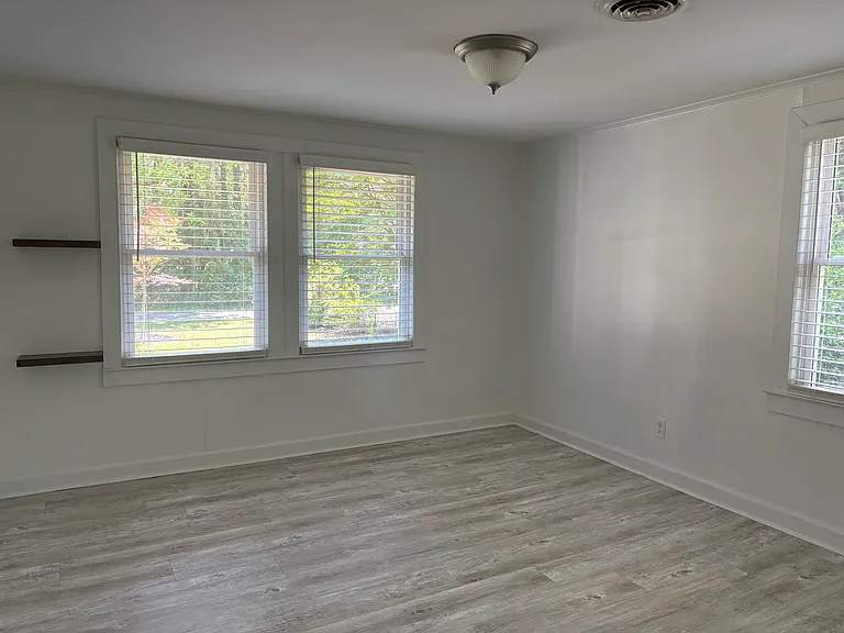 Primary bedroom with lots of windows for natural light.