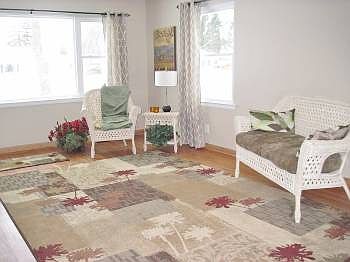 Very open, bright, and spacious living room with a stunning brick fireplace.