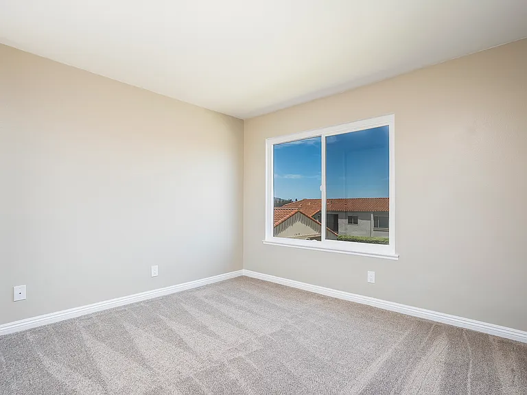 Second bedroom with new energy-efficient windows, carpet and elegant baseboards.