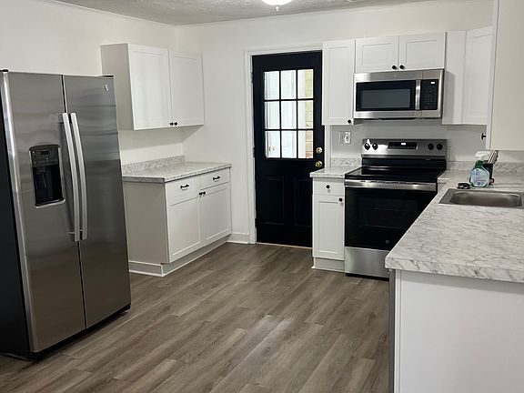 New refrigerator, stove, and microwave.