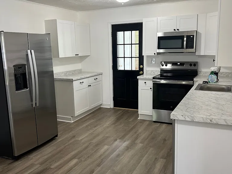 New refrigerator, stove, and microwave.