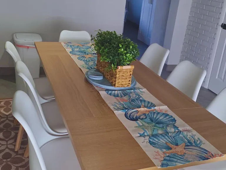 Decorated dining room with elegant centerpiece and runner