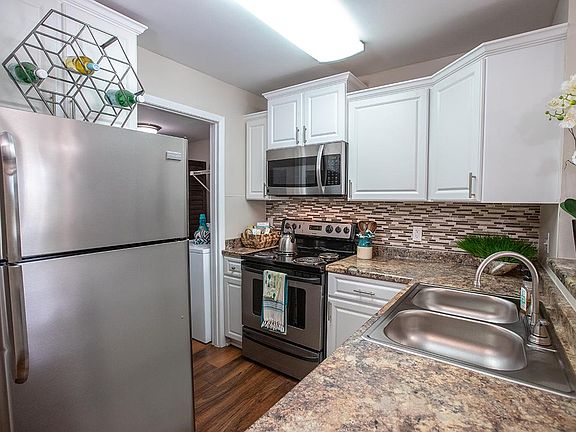 Kitchens feature stainless steel appliances.
