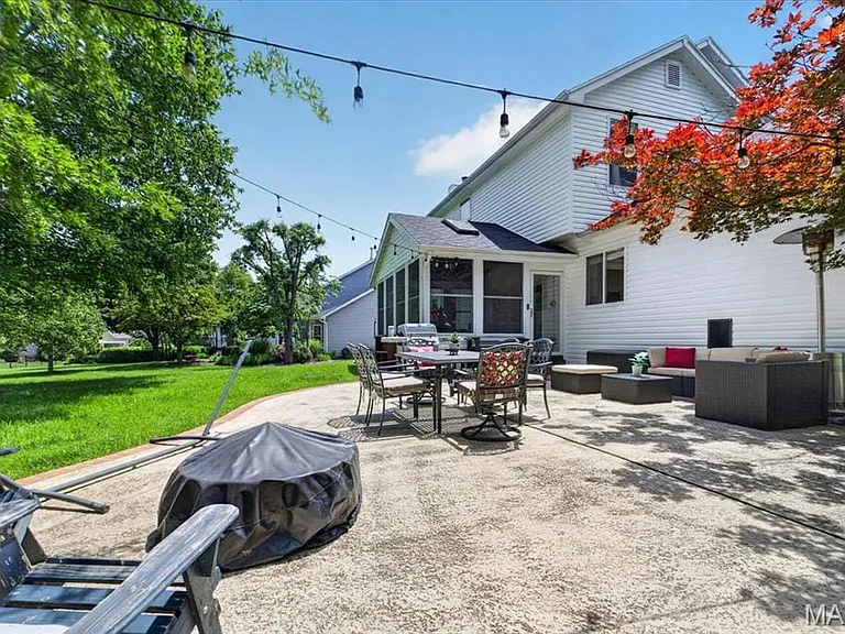 Expansive concrete patio offering multiple seating areas