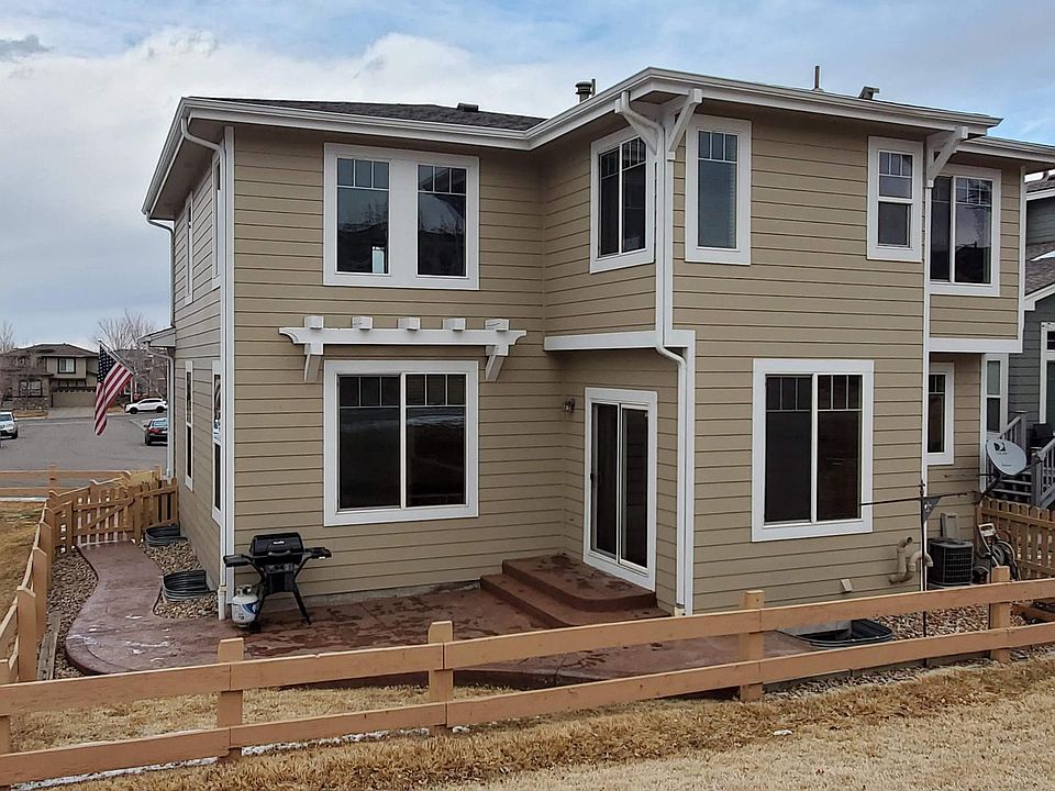 Back of house, with view from the open space park behind the house. Stamped concrete patio and path to the front of the house.