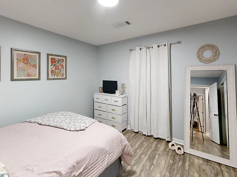 Bedroom one with large double reach-in closets. Photo is of a similar unit; available unit has the same floorplan. Furniture and decor not included.