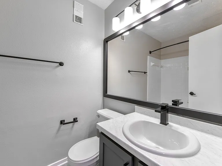 Bathroom with upgraded fixtures, lighting and hardware