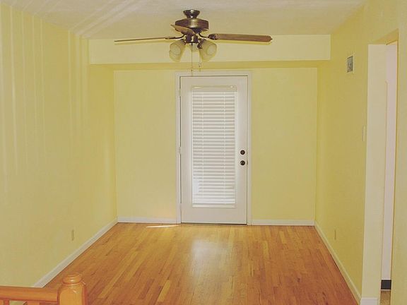 Dining room with hardwood floor connecting to kitchen and la