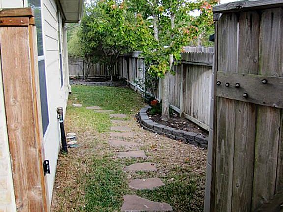 As you approach the front door, you can peer thru the gate into the backyard.  The HOA covers exterior maintenance and front yard lawn service.