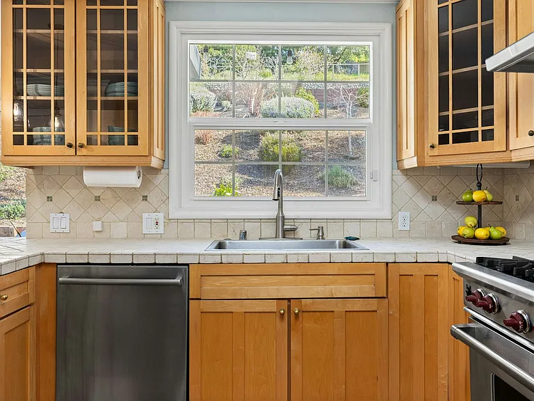 Serene views, smart design enjoy garden views while cooking or cleaning up, with ample counter space, a sleek dishwasher, and beautiful natural light.