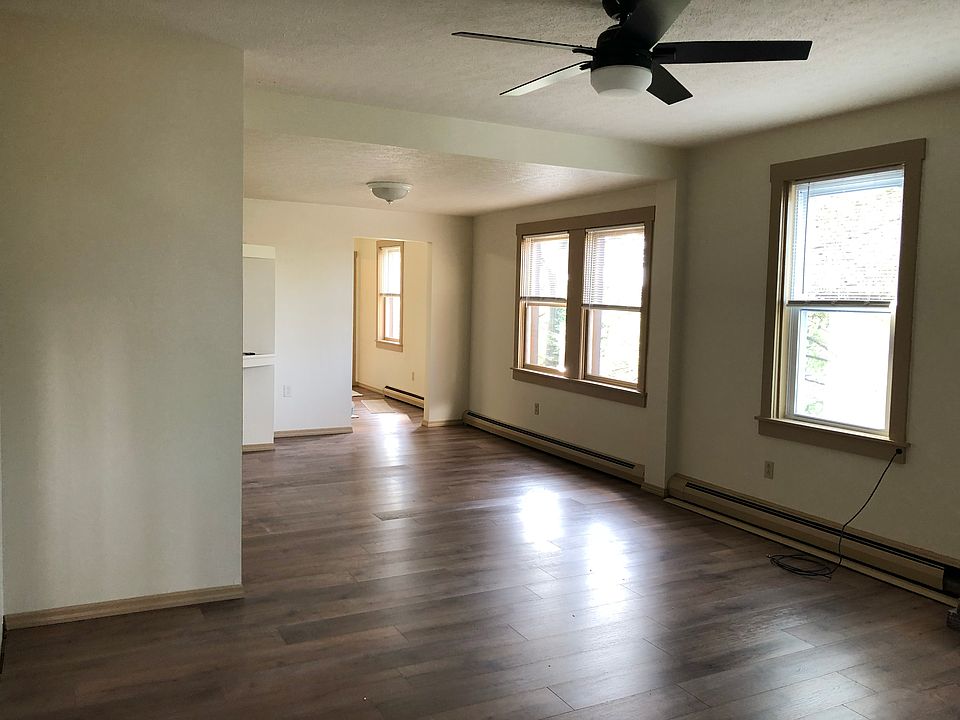 Open concept living/dining room with walk-in coat closet and coffee bar.